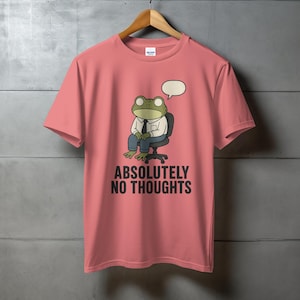 Pink t-shirt with cartoon frog wearing a suit and "ABSOLUTELY NO THOUGHTS" text.