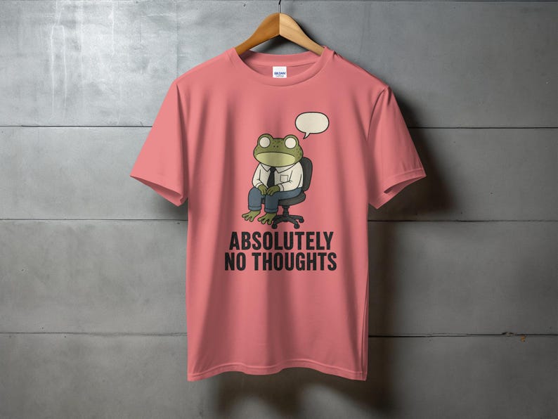 Pink t-shirt with cartoon frog wearing a suit and "ABSOLUTELY NO THOUGHTS" text.