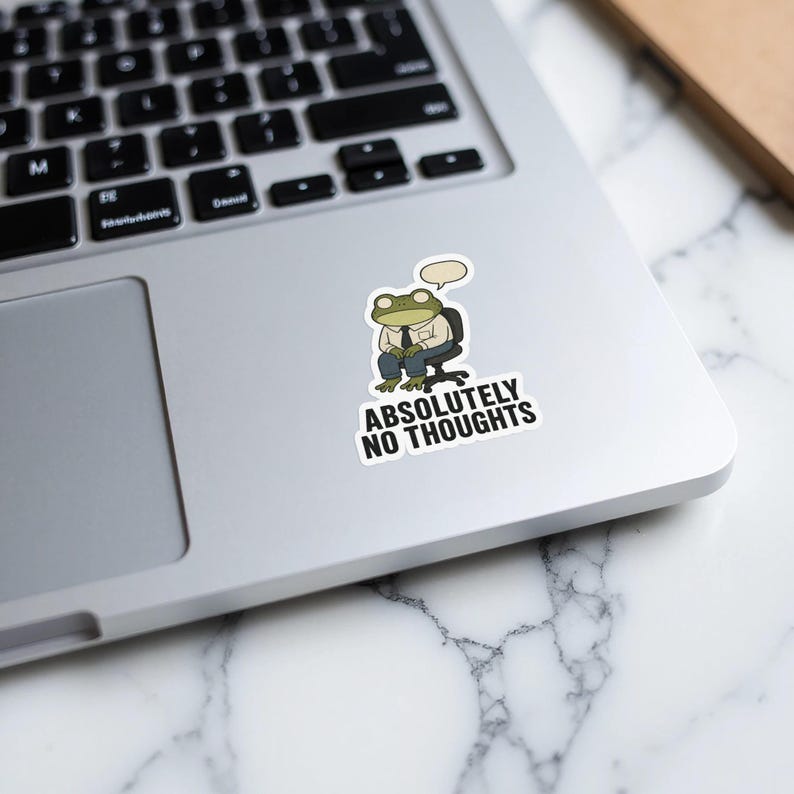 Frog in a suit sitting at a desk, "Absolutely No Thoughts" sticker.