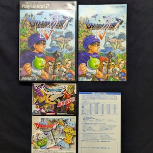 May include: A collection of Dragon Quest V video game items, including two PlayStation 2 game cases, a game manual, and promotional inserts. The game cases feature colorful artwork with characters and the game title. The items are on a dark background.