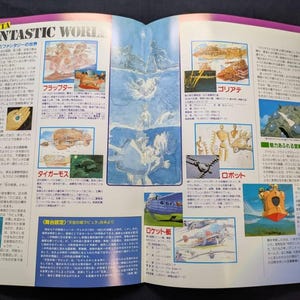 May include: A two-page spread from a Laputa Fantastic World publication featuring various illustrations of flying machines, robots, and characters. The layout includes columns of Japanese text, detailed sketches, and colorful scenes from the film.