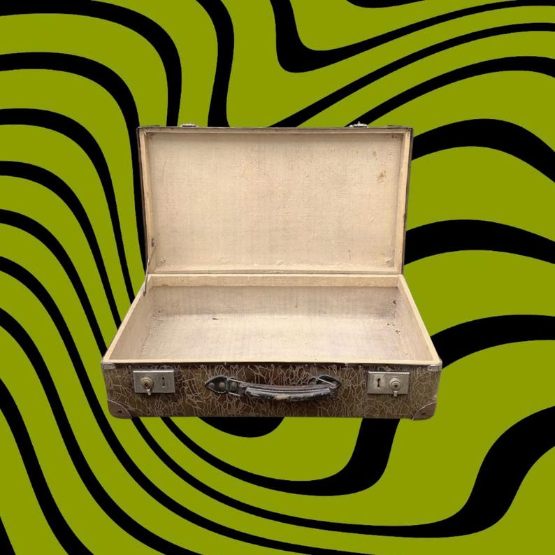 May include: An open vintage suitcase with a brown exterior and a light-colored interior. The suitcase has a handle and two metal latches. The background is a wavy pattern of black and green.
