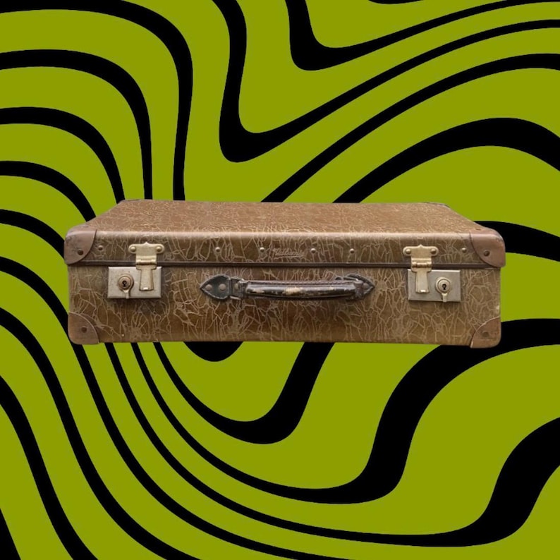 May include: A vintage brown suitcase with metal hardware, including corner protectors, latches, and a handle. The suitcase has a textured surface and is set against a green and black wavy background. A classic travel accessory.