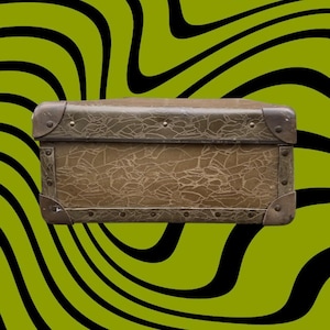 May include: A vintage brown trunk with metal corner protectors and rivets. The trunk has a textured surface and a rectangular shape. The background is a green and black wavy pattern.