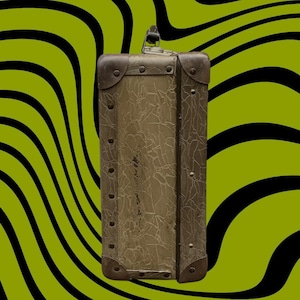 May include: An antique suitcase with a textured, olive-green exterior and metal corner reinforcements. The suitcase has a handle and is secured with a clasp. The background features a wavy pattern of black and lime green.