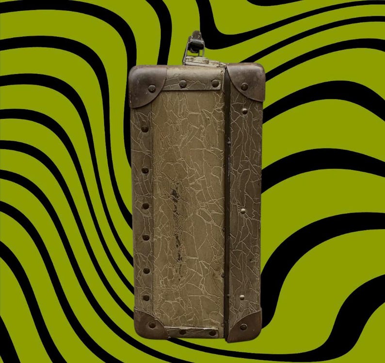 May include: An antique suitcase with a textured, olive-green exterior and metal corner reinforcements. The suitcase has a handle and is secured with a clasp. The background features a wavy pattern of black and lime green.