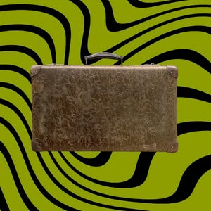 May include: A vintage brown suitcase with a textured surface and metal corner protectors. The suitcase has a black handle and is set against a green background with black wavy lines. A classic travel accessory.