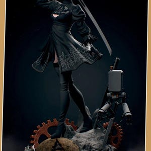 May include: A detailed figurine of a character in a black dress, holding a sword. The figure has white hair and a blindfold. The base features gears and a small robot. The overall theme is a video game character.