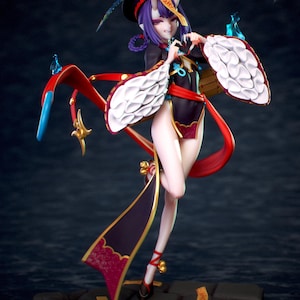 May include: A detailed figurine of a character in a black and red outfit with white accents. The figure has purple hair, horns, and is posed on a dark, textured base. The outfit includes flowing red ribbons and decorative elements.