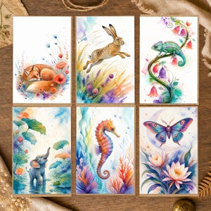 May include: A set of six rectangular greeting cards featuring watercolor illustrations of a sleeping fox, a jumping rabbit, a green chameleon on a vine, a baby elephant in water, an orange seahorse, and a blue butterfly above lotus flowers.