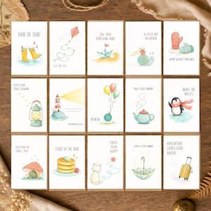 May include: A set of fifteen greeting cards featuring watercolor illustrations of various objects including yellow rain boots, a kite, a paper boat, a snail, mittens, a lantern, a lighthouse, balloons, a teapot, a penguin, a turtle, pancakes, a cat, an umbrella, and a suitcase, each with unique text.