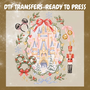 May include: A DTF TRANSFERS-READY TO PRESS graphic featuring a central castle illustration framed by a vine wreath with red bows, holly, and Mickey-shaped icons. Includes a nutcracker, mouse-ear headband, and ornaments on a light background.