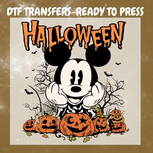 May include: A DTF transfer graphic featuring the text HALLOWEEN in orange dripping letters above a black and white cartoon mouse character with hands on cheeks. Below are several orange jack-o'-lanterns, a witch hat, and bare trees.