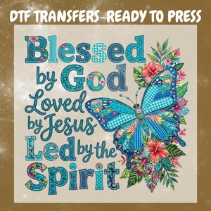 May include: A DTF transfer featuring the words "Blessed by God, Loved by Jesus, Led by the Spirit" in various blue fonts. A large blue butterfly with floral accents is on the right side of the design. The text "DTF TRANSFERS - READY TO PRESS" is at the top.