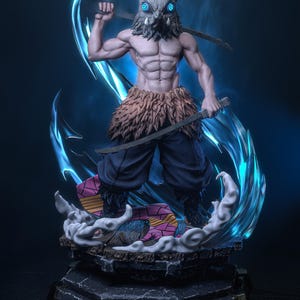 May include: A detailed figurine of a muscular character with a boar head mask, holding two swords. The figure is posed dynamically, surrounded by blue energy effects, and stands on a detailed base with a colorful platform.