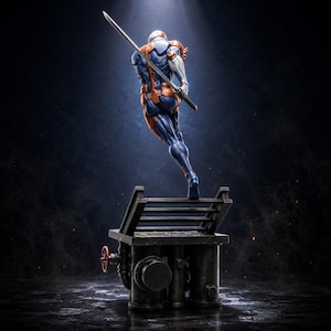 May include: A dynamic action figure of a character in a blue and orange armored suit, holding a long katana sword. The figure is posed mid-leap above a dark, industrial-style base featuring metallic pipes, a small red valve, and a metal grate.