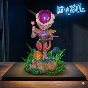 May include: A detailed figurine of a Dragon Ball Z character, Frieza, holding a lollipop. The figure is predominantly pink, purple, and orange, with a white headpiece and black horns. It stands on a small rock formation with green foliage and a glowing orange orb.
