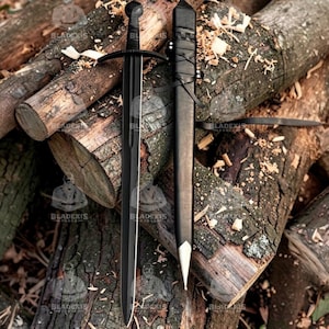 May include: A black sword with a crossguard and a rounded pommel, next to a matching black sheath. The sword and sheath are resting on a pile of wooden logs. The blade has a long, straight edge. The sheath has a silver tip.