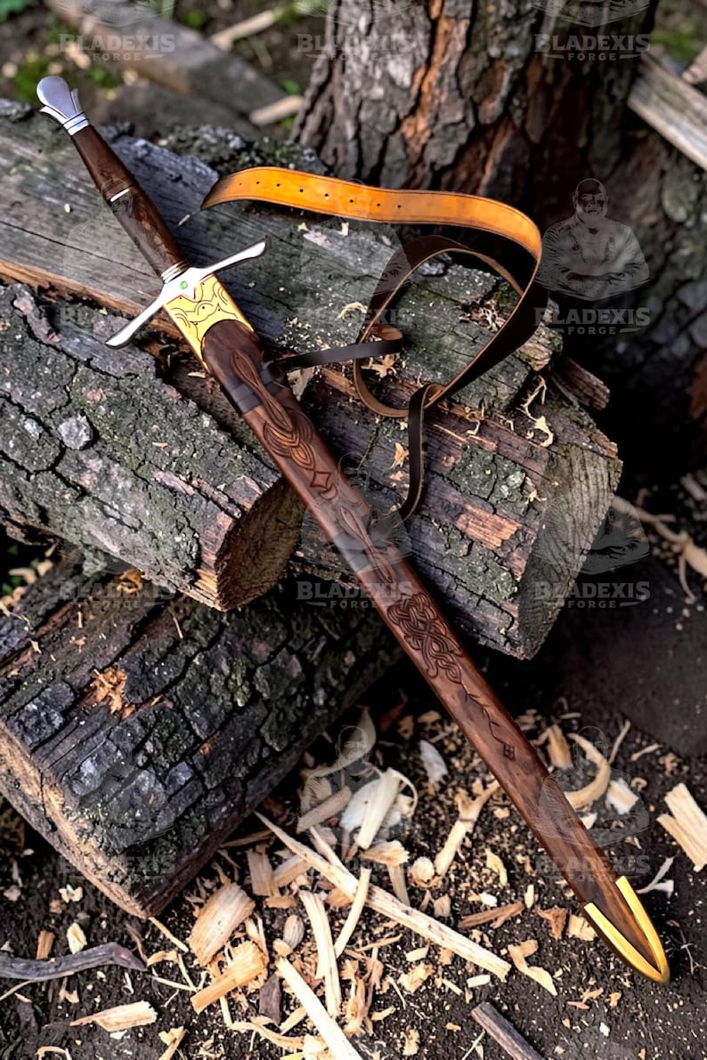 May include: A handcrafted sword with a dark wooden handle and blade, featuring intricate carvings and gold accents. The sword rests on a wooden surface with a leather strap. The blade measures approximately 30 inches.