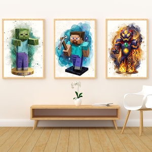 May include: Three framed watercolour prints featuring Minecraft characters. The prints depict a zombie, a character with a pickaxe, and a character in armour. Each print has a wooden frame and is set against a white background. The prints are displayed above a wooden console table.