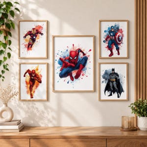 May include: A set of five framed wall art prints featuring watercolour-style illustrations of superheroes. The collection includes Spider-Man, Iron Man, Captain America, The Flash, and Batman, each depicted in dynamic poses with vibrant paint splatters.
