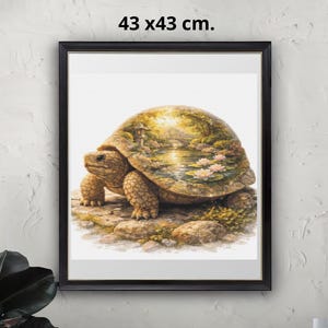 May include: A framed art print showing a watercolour illustration of a tortoise. The tortoise has a textured shell with green and gold tones. The artwork is set against a white background, framed in black, and measures 43 x 43 cm.