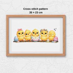 May include: A framed cross-stitch pattern featuring five yellow chicks perched on a branch. The chicks have various accessories, including a bow, flower crown, and an egg. The text "Cross stitch pattern 35 x 23 cm" is displayed above the image.
