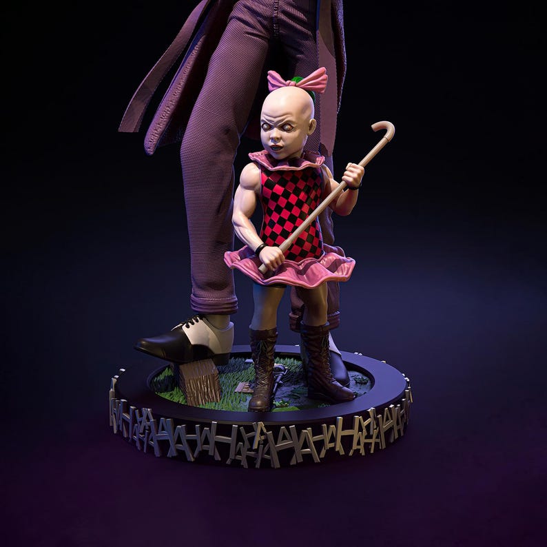 May include: A detailed figurine of a child in a pink and red chequered dress, holding a cane, standing next to a figure in a purple suit. The base is black with a repeating "HA HA HA" design. The child has a pink bow.