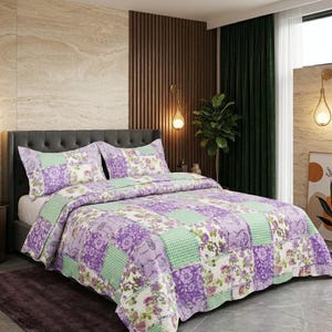 May include: A patchwork quilt and pillow set in shades of purple, green, and white. The quilt features floral and gingham patterns. The bed has a grey upholstered headboard.