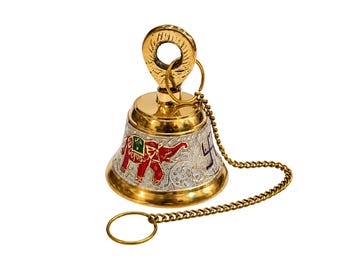 May include: A polished brass bell featuring a decorative handle with a circular loop. The bell body is adorned with an embossed red elephant motif and a dark blue swastika symbol, complemented by a gold-toned metal chain and a small ring attachment.