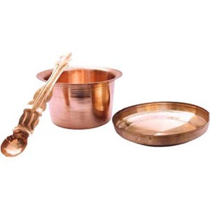May include: A copper-colored metal set, including a small bowl, a spoon, and a shallow dish. The bowl has a rounded shape with a flared rim. The spoon has an ornate handle. The dish is round and flat.