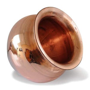 May include: A copper-colored, spherical vessel with a wide, flared rim. The polished surface reflects light, highlighting the vessel's shape and the surrounding environment. The interior is a darker shade of copper.