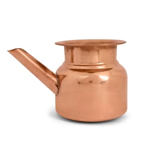 May include: A copper-coloured small pitcher with a spout and a wide, rounded body. The pitcher has a smooth, reflective surface and a slightly flared rim. The spout extends from the side, angled upwards. The overall design is simple and functional.
