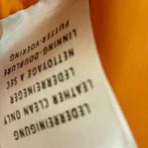 May include: A white ceramic mug with a black handle and the text "But First, Coffee" in a handwritten style. The mug is on a white surface. The mug is approximately 4 inches tall.