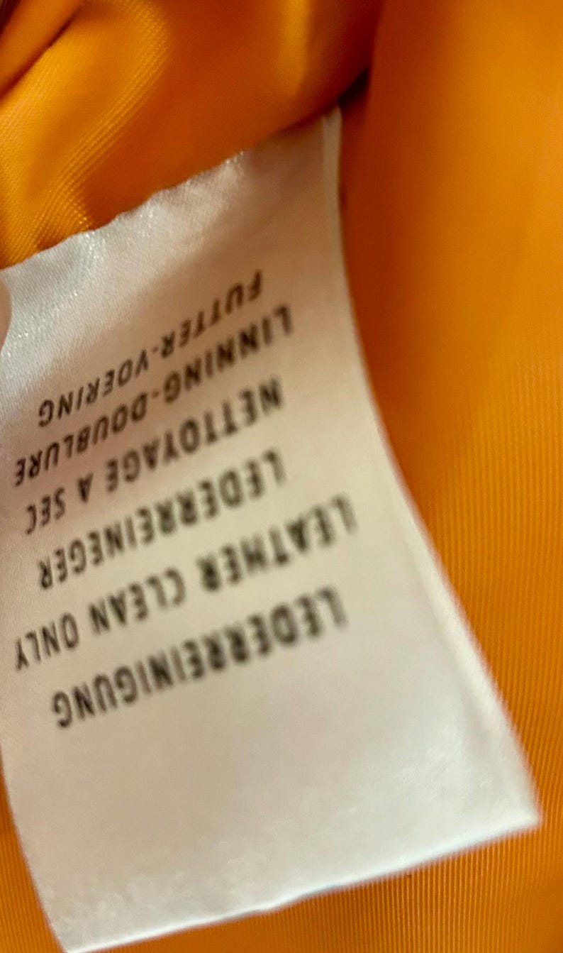 May include: A white ceramic mug with a black handle and the text "But First, Coffee" in a handwritten style. The mug is on a white surface. The mug is approximately 4 inches tall.