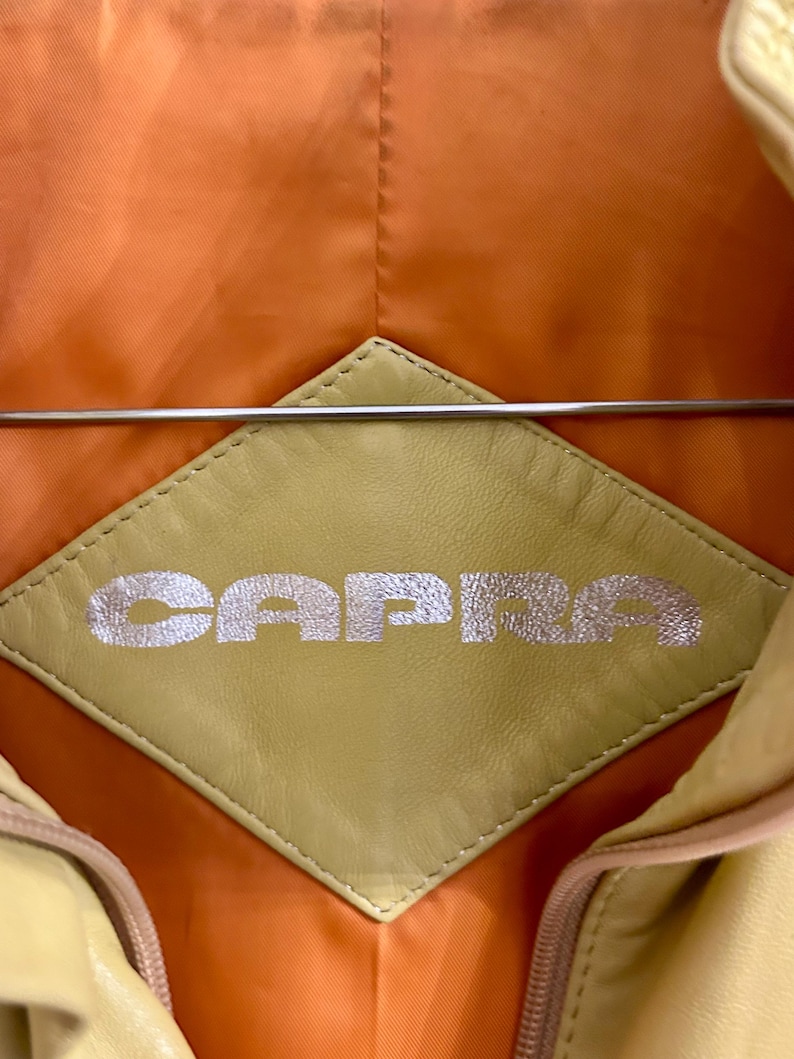 May include: A white ceramic mug with a black handle and the text "But First, Coffee" in a black, bold font. The mug is sitting on a white surface.