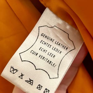 May include: A white ceramic mug with a black handle and the text "But First, Coffee" in a black, bold font. The mug is on a white surface.