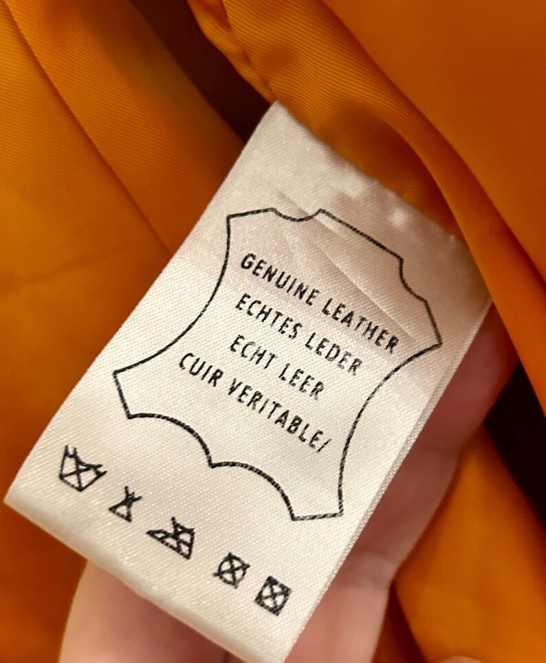 May include: A white ceramic mug with a black handle and the text "But First, Coffee" in a black, bold font. The mug is on a white surface.