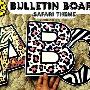 May include: Three large cutout letters A, B, and C featuring animal print patterns. The letter A has a mix of tiger stripes and leopard spots. The letter B features a white background with black and pink leopard spots. The letter C has black and white zebra stripes.