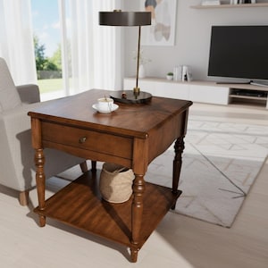 May include: A dark brown wooden side table with a drawer and a lower shelf. The table has turned legs and a small woven basket on the shelf. A lamp with a dark shade and a small teacup and saucer sit on top.