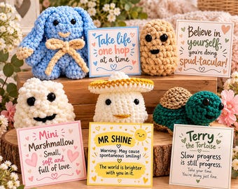 May include: A collection of six crocheted plush figures including a blue bunny, a tan potato, a white cloud, a white mushroom, and a green turtle, each paired with a card featuring text like Take life one hop at a time and Mr. Shine.