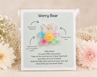 May include: A Worry Bear card in a clear plastic sleeve. The card features a clear bear with colorful bead accents. Text on the card reads, "Big ears for listening," "A heart full of love," and "Take me with you; I'm pocket sized!"