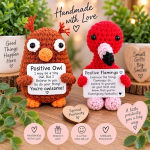 May include: Two handmade crochet figures, a brown owl and a red flamingo, each holding a white sign with printed text. The owl sign reads Positive Owl, I may be a tiny Owl, But I Believe in you. Go do your thing! You're owlsome! The flamingo sign reads Positive Flamingo, Embrace the things Flamingos do... believe in yourself, do your best and know that you're flamingoing fantastic!