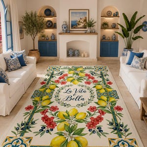 May include: A living room scene featuring white sofas with blue and white patterned pillows. A large rug with a lemon and floral design dominates the floor, with the text "La Vita è Bella". Blue accents and decor complete the Mediterranean theme.