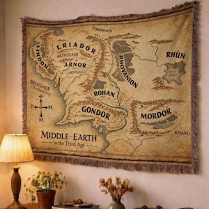 May include: A set of three ceramic mugs with a speckled, matte finish. The mugs are in shades of cream, light gray, and dark gray. Each mug has a simple, minimalist design and a rounded handle.