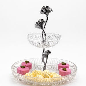 May include: A set of three ceramic mugs with a speckled, matte finish. The mugs are in shades of cream, light gray, and dark gray. Each mug has a simple, minimalist design, perfect for coffee or tea.