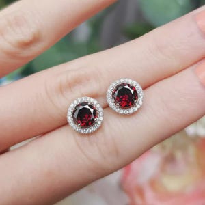 Round Cut Red Ruby Halo Stud Earrings • 14K White Gold Plated Sterling Silver