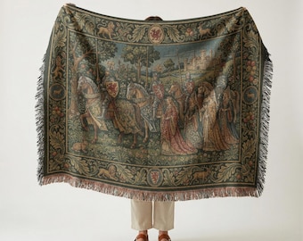 May include: A tapestry throw blanket featuring a medieval scene with knights, a castle, and figures in period clothing. The blanket has a dark green border with decorative elements and fringe.