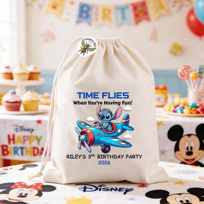 May include: A cream-colored drawstring bag featuring a cartoon image of Stitch piloting a blue airplane. The text "TIME FLIES When You're Having Fun!" and "RILEY'S 3RD BIRTHDAY PARTY 2026" are printed on the bag. A bumble bee sticker is on the top.