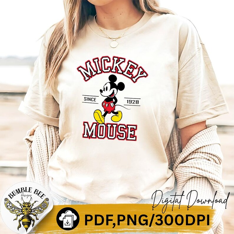May include: Beige t-shirt featuring a Mickey Mouse graphic. The design includes the words "MICKEY MOUSE" in red and white, with "Since 1928" underneath. The shirt is a digital download, available in PDF and PNG formats.